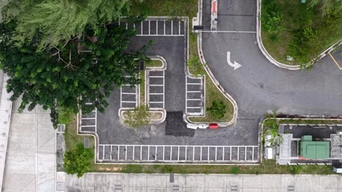 Aerial View of Empty Parking Lot with Solar Streetlights and Lush Greenery Stockbeeldmateriaal 345835187