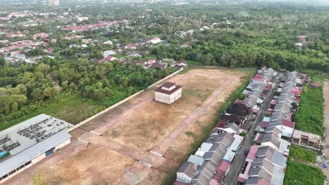 Aerial View of Empty Plot and Red-Roof Building Stock-Footage 347350283