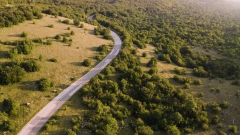 Aerial view of empty road crossing the countryside during sunset, Croatia. Stock Footage 139048173