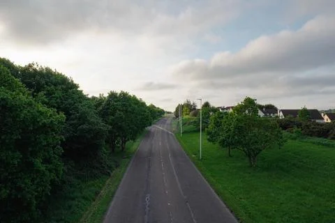 An aerial view of an empty road surrounded by lush greenery Stock Photos