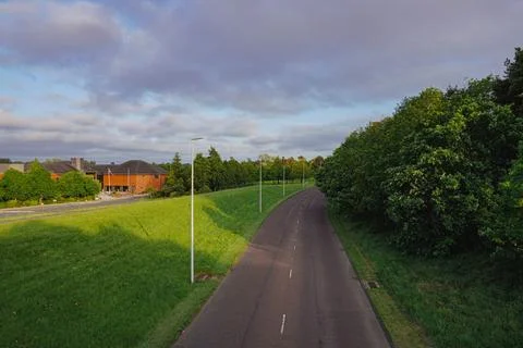 An aerial view of an empty road surrounded by lush greenery Foto stock