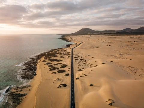 Aerial view of an empty road through the dunes Stock Photos