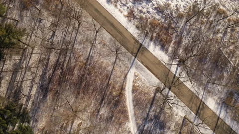 Aerial view of empty rustic road in winter Stock Footage 145583719