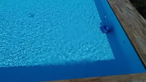 Aerial view of an empty swimming pool with cleaner robot Stock Footage 87147686