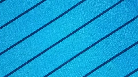 Aerial view of an empty swimming pool for sports swimming, with clear blue water Stock Footage 282303954