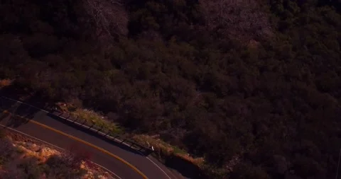 Aerial view of empty winding road in the mountains Stock Footage 136340789