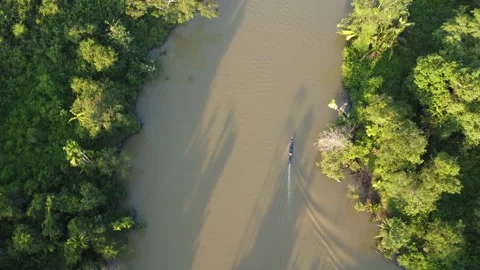 Aerial view of an engine boat passing through a river with brown river wate.. Stock Footage 247940795