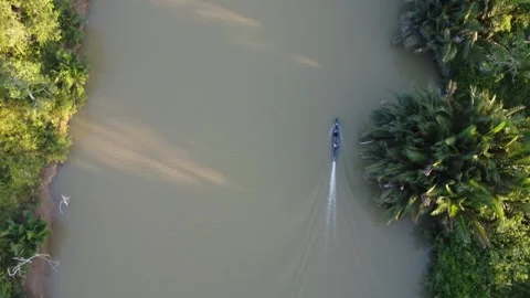 Aerial view of an engine boat passing through a river with brown river wate.. Stock Footage 247941005
