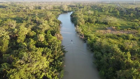 Aerial view of an engine boat passing through a river with brown river wate.. Stock Footage 247941006