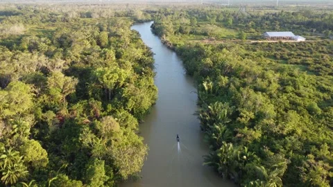 Aerial view of an engine boat passing through a river with brown river water Stock Footage 247941021