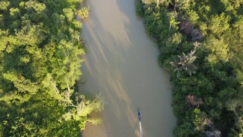 Aerial view of an engine boat passing through a river with brown river water Stock Footage 247941206