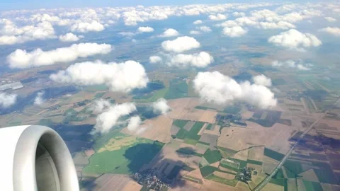 Aerial view of engine over vast farmland under cloudy sky in flight Stock Footage 331534367