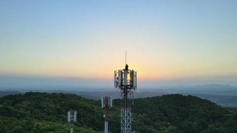 Aerial view of a Engineer doing maintenance on Radio towers in the mountains. Stock Photos