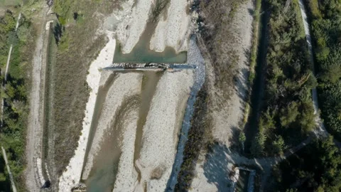 Aerial View of Engineered Riverbed with Concrete Channels, Bridges, Shallow Stock Footage 327633435