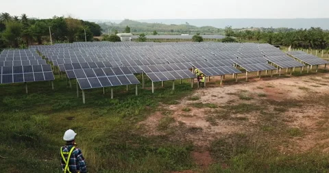 Aerial view engineering team inspecting or repairing solar cells on solar far Stock Footage 131474206