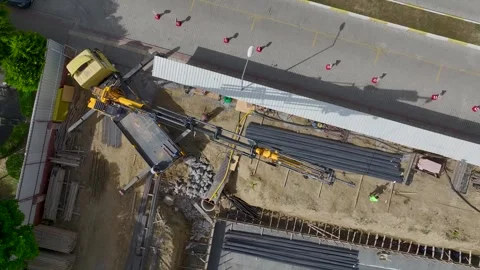 Aerial View: Engineers and workers collaborate on foundation insulation and Stock Footage 296095160
