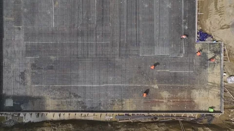 Aerial View: Engineers and workers focus on foundation insulation and metalwork Video stock 296096466