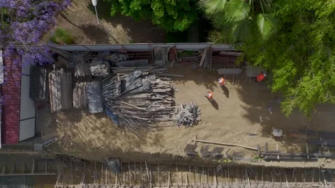 Aerial View: Engineers and workers handle insulation tasks and metalwork with Stock Footage 296096696