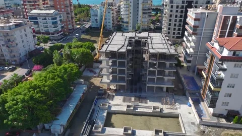 Aerial View: Engineers and workers assemble a towering crane on this vibrant Stock Footage 296102842