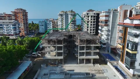 Aerial View: Engineers ensure high-quality work as workers pour concrete and Stock Footage 296193836
