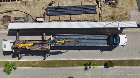 Aerial View: Engineers inspect metal structures while builders apply foundation Stock Footage 296095553