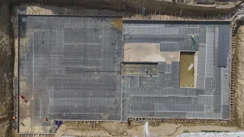 Aerial View: Engineers oversee insulation and metal assembly tasks on a large Stock Footage 296096552