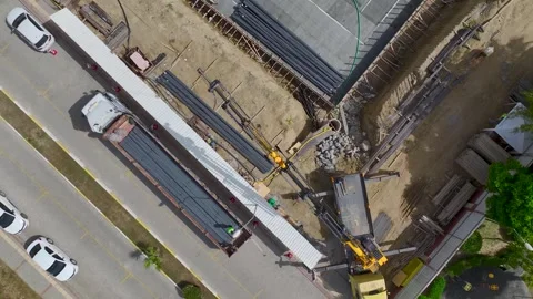 Aerial View: Engineers supervise foundation insulation and metalwork on a Stock Footage 296096257