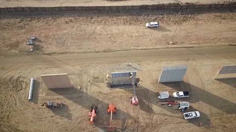 Aerial view of engineers working on large walls near a town 3 Stock Footage 114084092