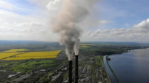 Aerial view Environmental pollution. Two tall pipes that emit black smoke into Stock Footage