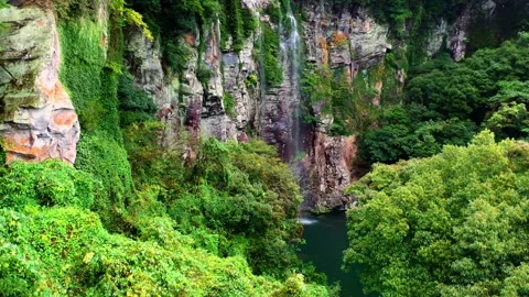 Aerial view of Eongtto Waterfall in Jeju Island, South Korea Stock Footage 296580100