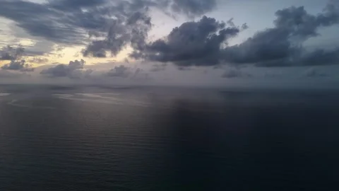 Aerial view of epic clouds at sunrise captured in slow motion with warm sun.. Video stock 317189254