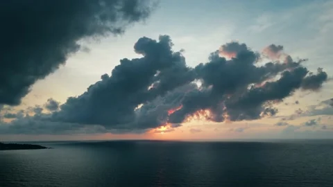 Aerial view of epic dark clouds flying into camera, scenic sunrise sun at sea Stock Footage 233593703