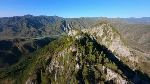 Aerial view epic mountain summit ridge covered green trees forest rocky valley Stock Footage 195992277