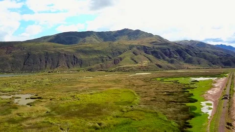 Aerial View of Epic Mountains, Sky, Clouds, Field, Swamp and Lake. Stock Footage 75749922