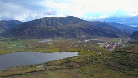 Aerial View of Epic Mountains, Sky, Clouds, Field, Swamp and Lake. Stock Footage 75774873