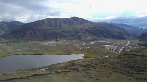 Aerial View of Epic Mountains, Sky, Clouds, Field, Swamp and Lake. Stock Footage 75774874