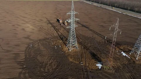 Aerial view of erector workers strengthen a newly installed power line pylon Stock Footage 231412147