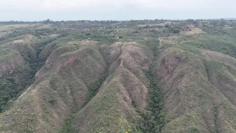 Aerial View of Eroded Hills and Dry Valley Terrain Stock Footage 325593359