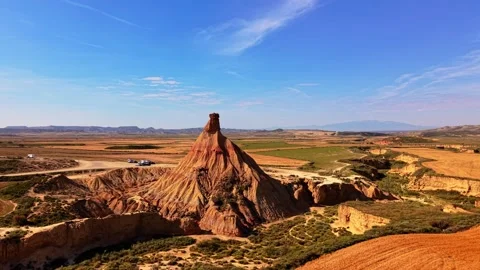 Aerial view of an eroded rock spire in desert badlands 스톡 동영상 343324299