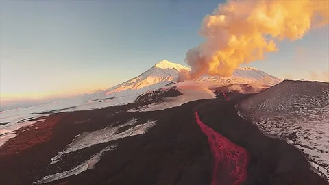 Aerial view of an erupting volcano with flowing lava Stock Footage 337033405
