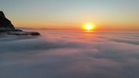 Aerial view of Europa Point at sunset over clouds, Gibraltar. Stock Footage 346643148