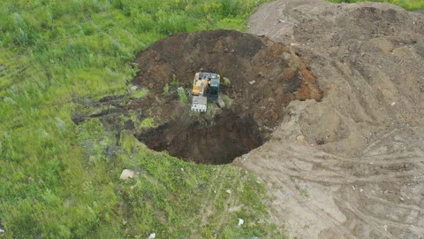 Aerial view of the excavator digging a large pit Stock Footage 111955377