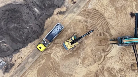 Aerial view of excavator loading sand into a truck at a quarry, showcasing the Video stock 341105183