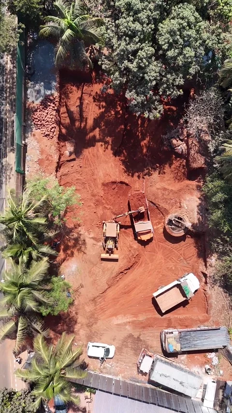 Aerial View of Excavator Loading Soil Into Trucks at Site Video stock 343882313