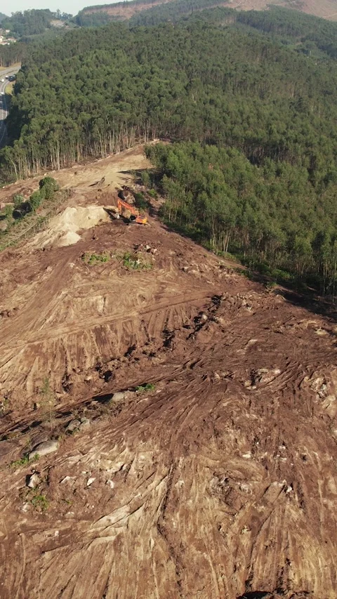 Aerial View excavator operating on a hillside Видео 336377395