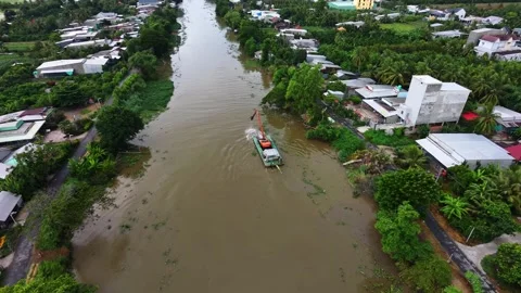 Aerial view of an excavator on a pontoon navigating river using its bucket Stock-Footage 341229684