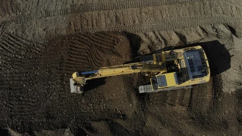 Aerial view of the excavator. The work of the excavator. Digger from the air. Stock Footage 125536600