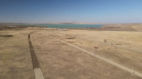 Aerial view of excavator working in rural landscape near reservoir Stock Footage 337479501