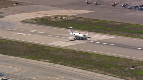 Aerial view of executive jet taking off from airstrip. Shot in 2007. Stock Footage 59544405