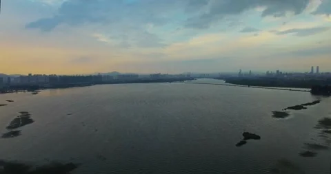 Aerial View of Expansive Lake at Golden Hour with Glowing Sunset Reflections Stock Footage 341908717